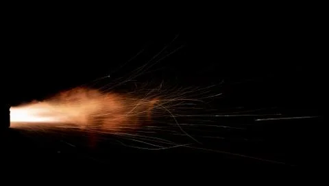The texture of a firearm shot , a bright flash of flame on a black background Stock Photos