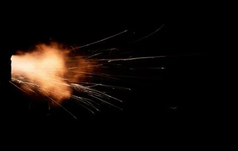 The texture of a firearm shot , a bright flash of flame on a black background Stock Photos