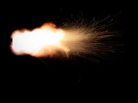 The texture of a firearm shot , a bright flash of flame on a black background Stock Photos