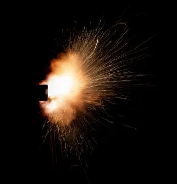 The texture of a firearm shot , a bright flash of flame on a black background Stock Photos
