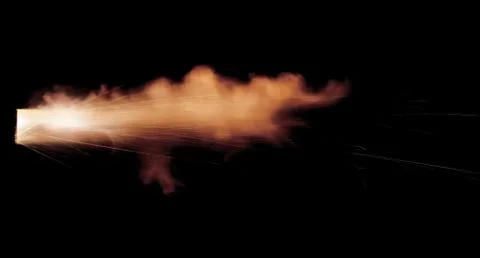 The texture of a firearm shot , a bright flash of flame on a black background Stock Photos