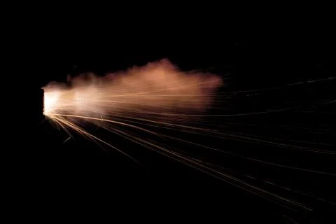 The texture of a firearm shot , a bright flash of flame on a black background Stock Photos