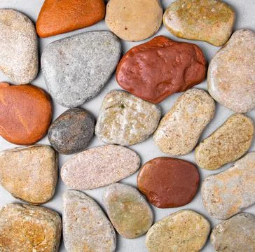 Texture from flat river stones on a gray background Stock Photos