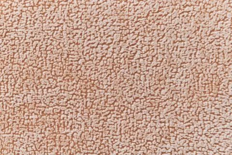 The texture of the flock material beige. Stock Photos
