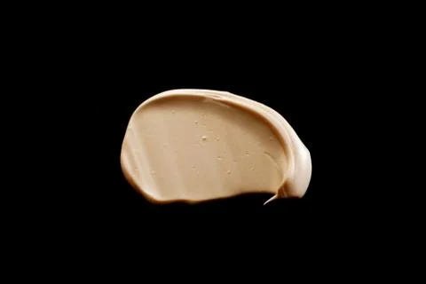 The texture of a foundation liquid. Black background. Stock Photos