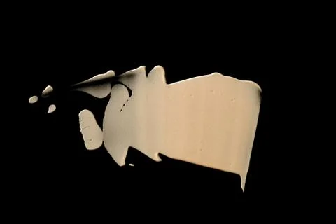 The texture of a foundation liquid. Black background. Stock Photos