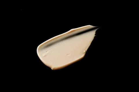 The texture of a foundation liquid. Black background. Stock Photos