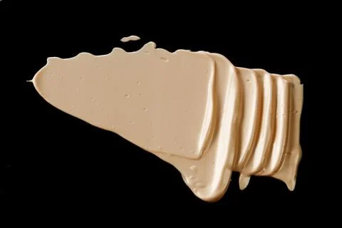 The texture of a foundation liquid. Black background. Stock Photos