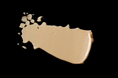 The texture of a foundation liquid. Black background. Stock Photos