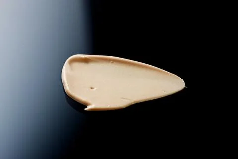 The texture of a foundation liquid. Black background. Foto stock