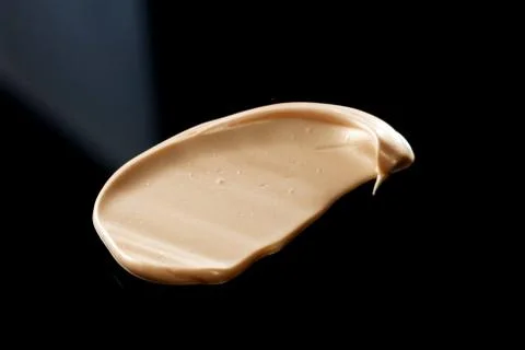 The texture of a foundation liquid. Black background. Foto stock