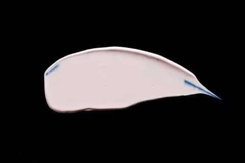 The texture of a foundation liquid. Black background. Stock Photos