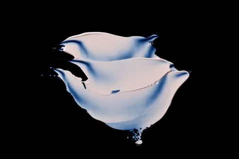 The texture of a foundation liquid. Black background. Stock Photos