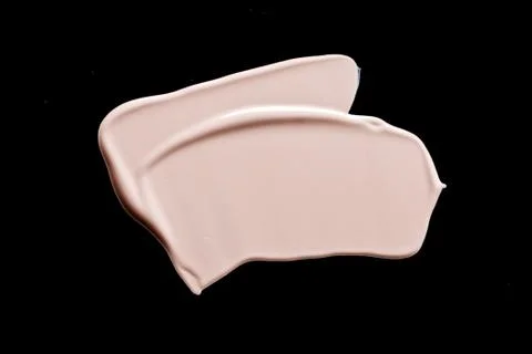 The texture of a foundation liquid. Black background. Stock Photos