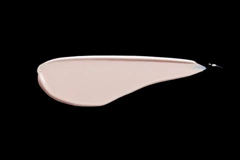 The texture of a foundation liquid. Black background. Stock Photos