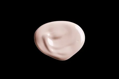 The texture of a foundation liquid. Black background. Stock Photos