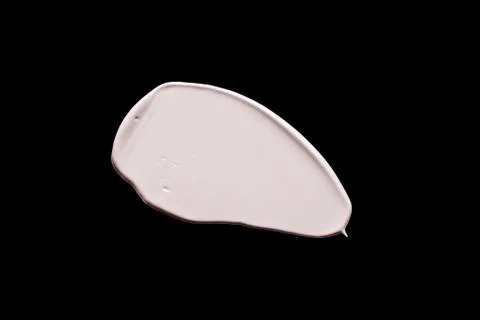 The texture of a foundation liquid. Black background. Stock Photos