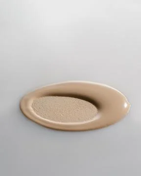 The texture of the foundation with a trace of sponge. Stock Photos