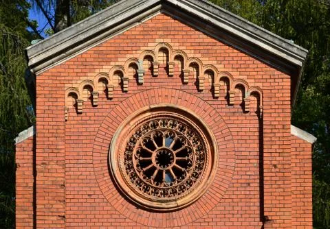 Texture front part of an ancient brick crypt with a round patterned carved wi Stock Photos