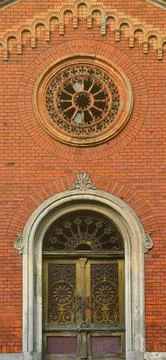 Texture front part of an ancient brick crypt with a round patterned carved Stock Photos
