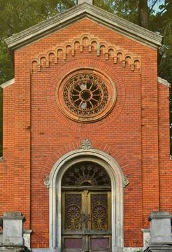 Texture front part of an ancient brick crypt with a round patterned carved Stock Photos