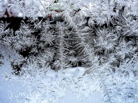 Texture of frosty patterns on the winter window Stock Photos