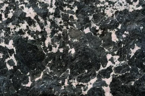 The texture of the gabbro. Black granite with white veins. Minerals texture. Stock Photos