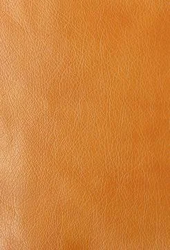 Texture of genuine leather, artificial leatherette orange background Stock Photos