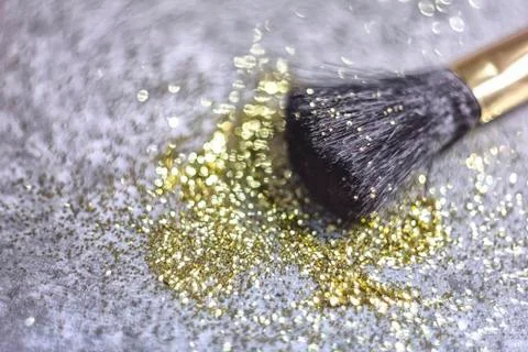 Texture of gold glitter on the makeup brush Stock Photos