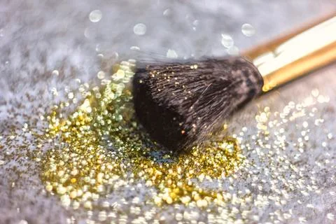 Texture of gold glitter on the makeup brush Stock Photos