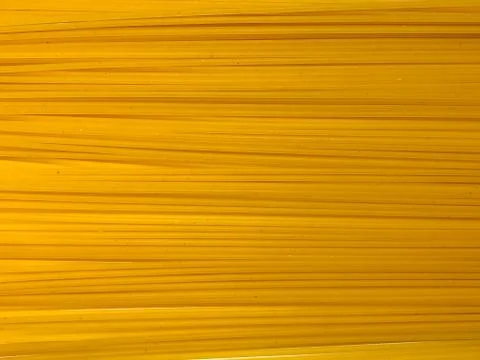 Texture of golden appetizing spaghetti. Stock Photos