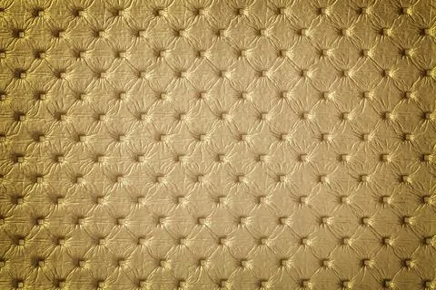 Texture of golden leather background with capitone pattern with vignette. Stock Photos