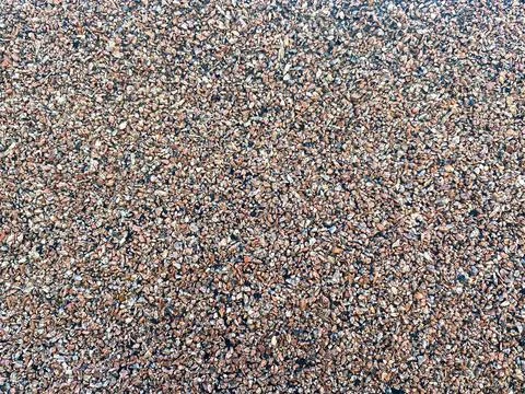 The texture of a gouged rough stone surface with small sharp stones of differ Stock Photos