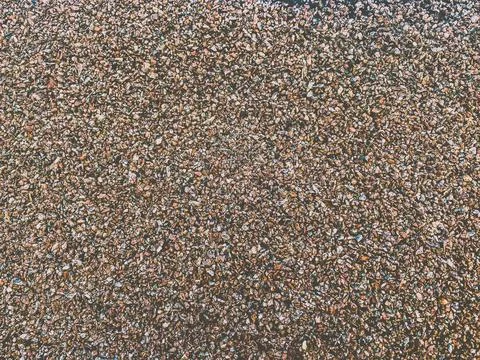 The texture of a gouged rough stone surface with small sharp stones of differ Stock Photos