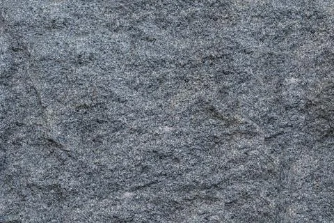 Texture gray granite rough untreated natural stone with white impregnations b Stock Photos