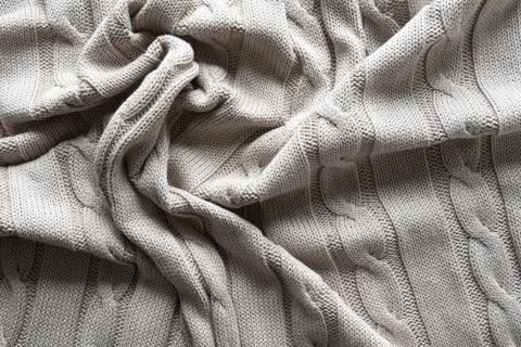 Texture gray knitted fabric with a pattern Stock Photos