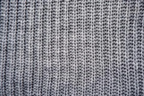 The texture of a gray knitted woolen jacket, sweater Stock Photos