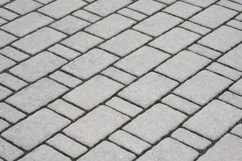 Texture of gray paving slabs. Diagonal line tiles for footpath background. 库存照片