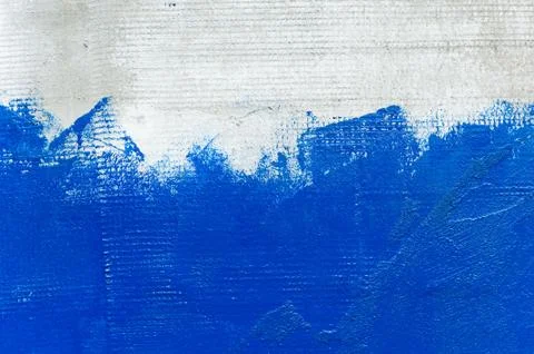Texture of a gray rough wall that is half painted with bright blue paint Stock Photos