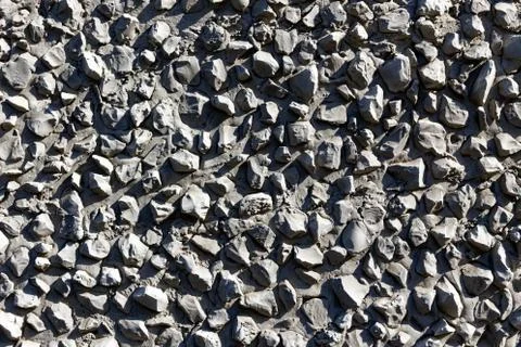 Texture of a gray stone wall. Decorative wall decoration with cement and rubb Stockfoto's