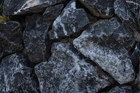 Texture of gray stones with white inserts. Stock Photos