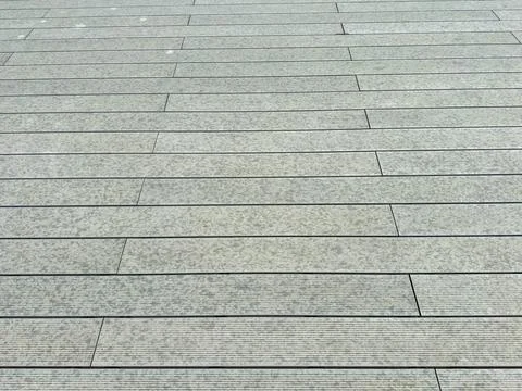 Texture of a gray wooden deck surface during daylight hours in an urban area 스톡 사진