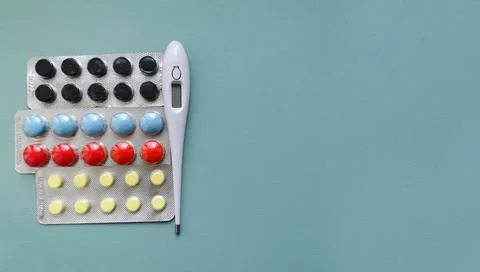 Texture green background with thermometer and medicines Stock Photos