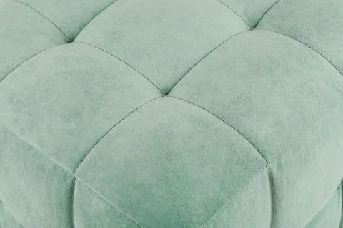 Texture green fabric. Background of a soft pouf. Stock Photos