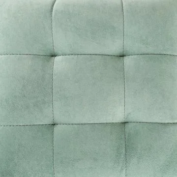 Texture green fabric. Background of a soft pouf. Stock Photos