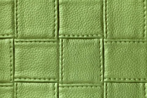 Texture of green leather background with square pattern and stitch, macro. Foto stock