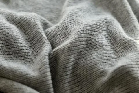 Texture of grey knitted wool fabric. 스톡 사진