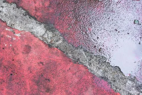 The texture of half wet of the rough red cement floor splitted by the diagona Stock Photos