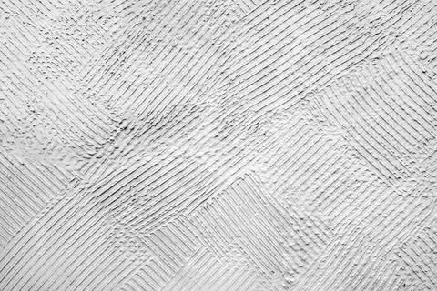 Texture of a hand-troweled white plaster wall featuring a repeating herring.. Stock Photos