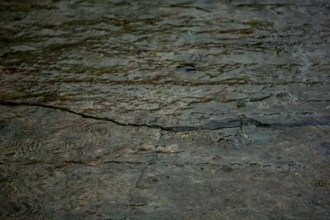 A texture has been created by the accumulation of rainwater on the ground Stock Photos